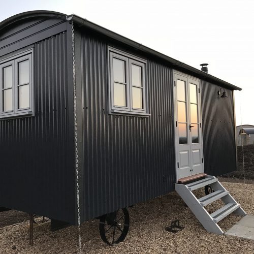 The Harrogate Huts XL shepherd hut external corrugated tin Cladding, in black.