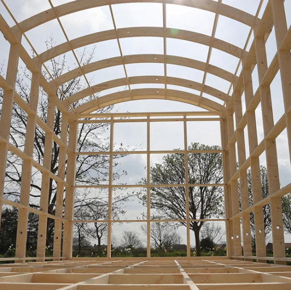 Timber frame structure of an XL shepherd hut self-build bundle with an arched roof design.